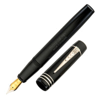 A large black fountain pen with gold trim and a classic cigar shape.